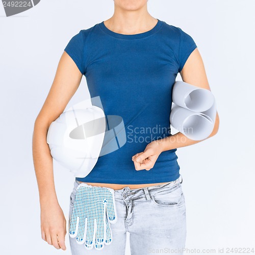 Image of woman architect with helmet and blueprint