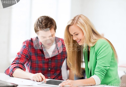 Image of students looking at tablet pc at school