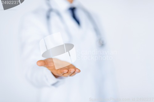 Image of male doctor holding something in his hand