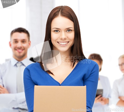 Image of smiling woman holding cardboard box