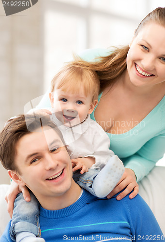 Image of happy parents playing with adorable baby