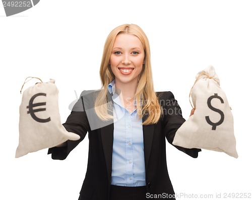 Image of businesswoman holding money bags with euro