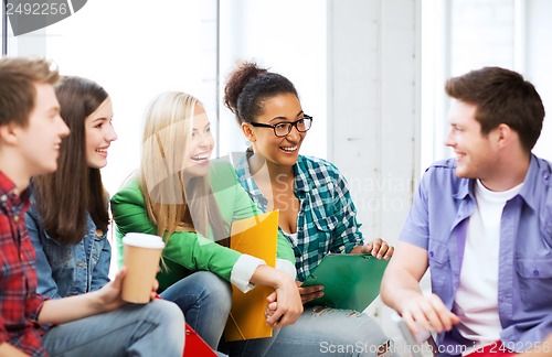 Image of students communicating and laughing at school