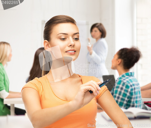 Image of student writing something in the air with marker