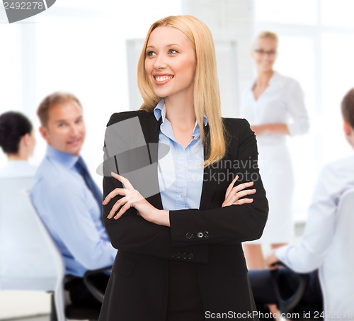 Image of attractive young businesswoman in office