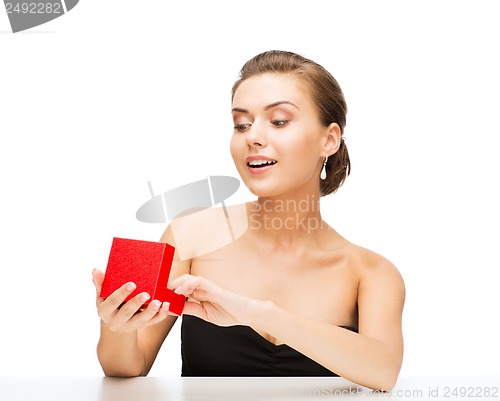 Image of woman with diamond earrings and gift box