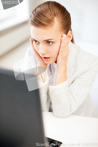 Image of stressed businesswoman with computer