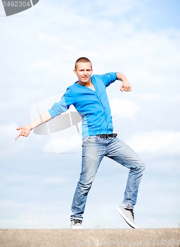 Image of handsome boy making dance move