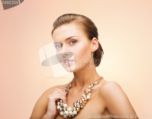 Image of woman wearing pearl statement necklace