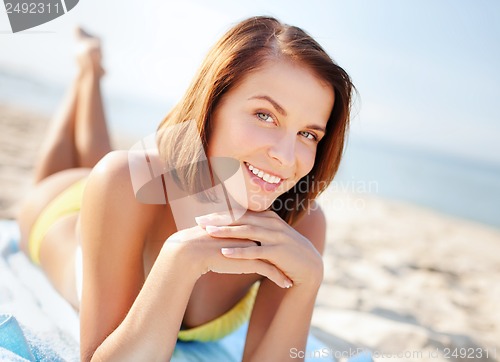 Image of girl sunbathing on the beach