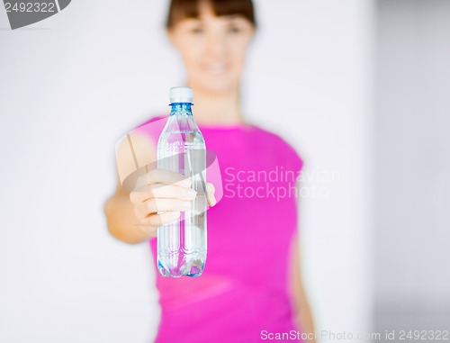 Image of sporty woman with bottle of water