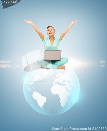 Image of woman with laptop and sphere globe
