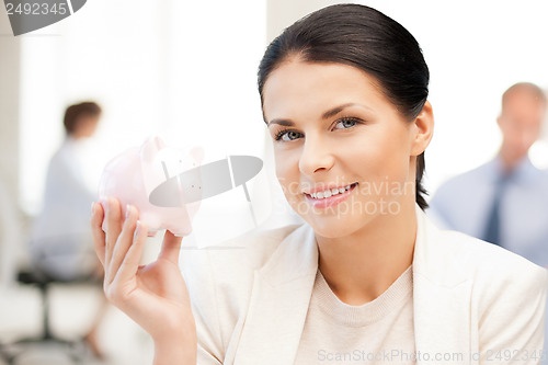 Image of woman with piggy bank