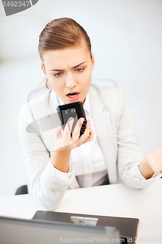 Image of woman shouting into smartphone