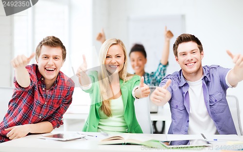 Image of students showing thumbs up at school