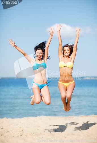 Image of girls jumping on the beach