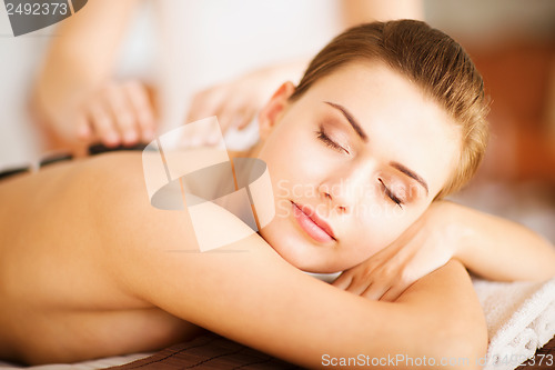 Image of woman in spa with hot stones