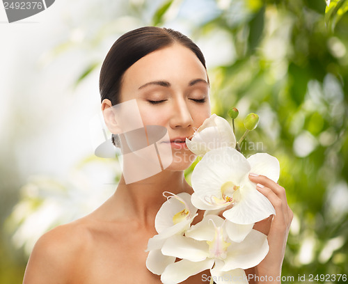 Image of beautiful woman with orchid flower