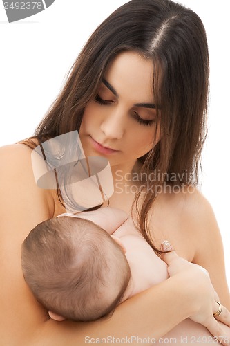 Image of happy mother feeding her adorable baby