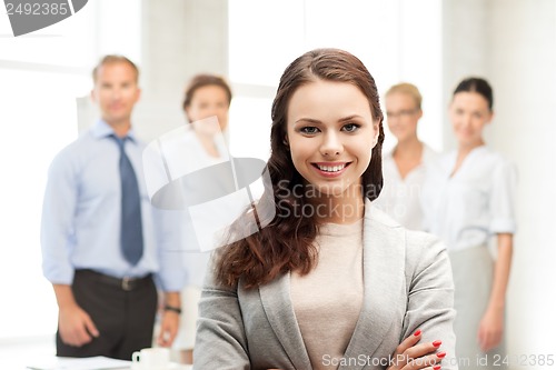 Image of attractive young businesswoman in office