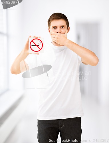 Image of young man holding no smoking sign