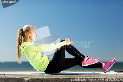 Image of woman doing sports outdoors