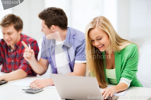 Image of students writing test or exam in lecture at school