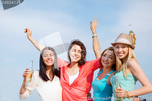 Image of girls with drinks on the beach