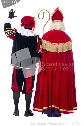 Image of Sinterklaas and Black Pete from the back