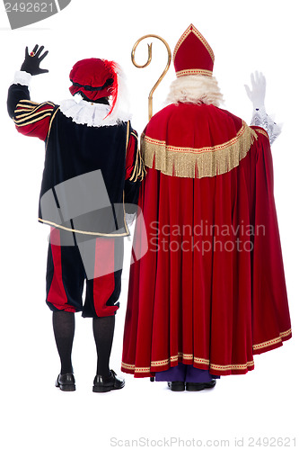 Image of Sinterklaas and Black Pete from the back