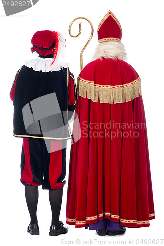 Image of Sinterklaas and Black Pete from the back