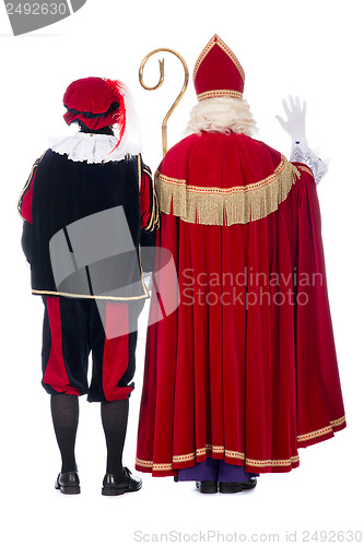 Image of Sinterklaas and Black Pete from the back