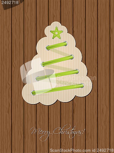 Image of Christmas greeting with shoe lace tree and wooden background