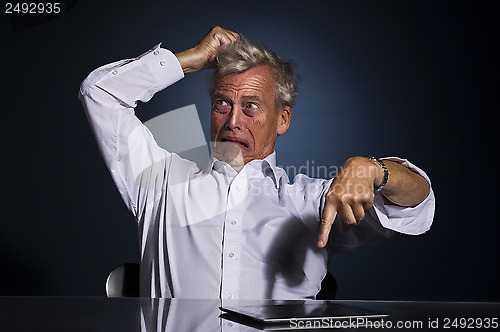 Image of Upset frustrated senior man pointing at his tablet