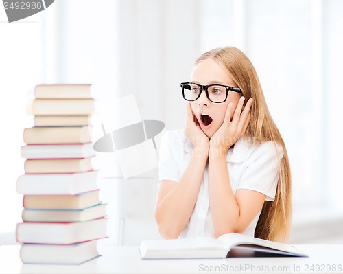 Image of girl with many books at school