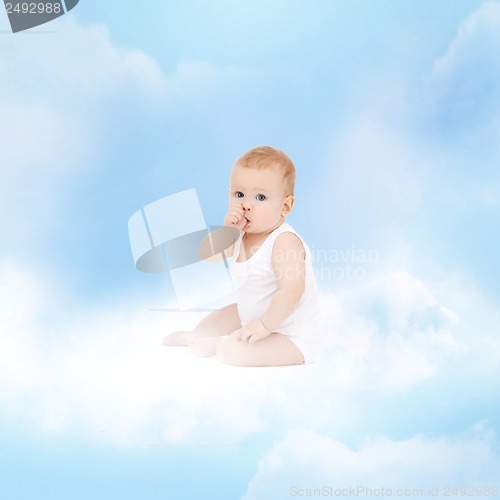 Image of smiling baby sitting on the cloud