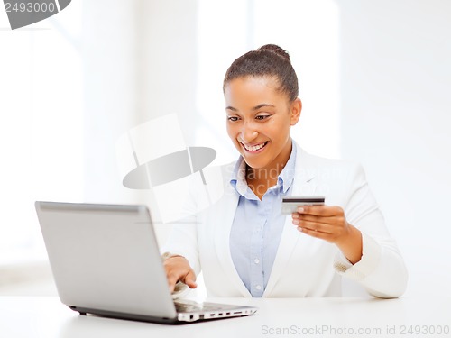 Image of businesswoman with laptop and credit card