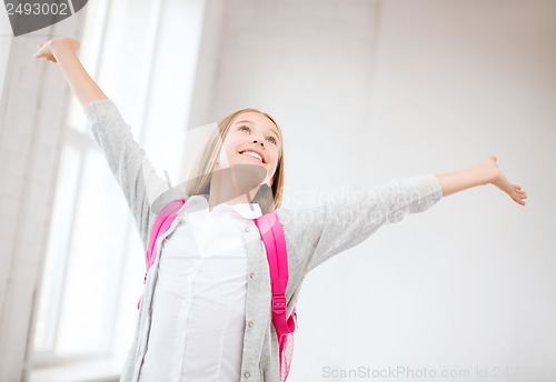 Image of happy teenage girl with raised hands