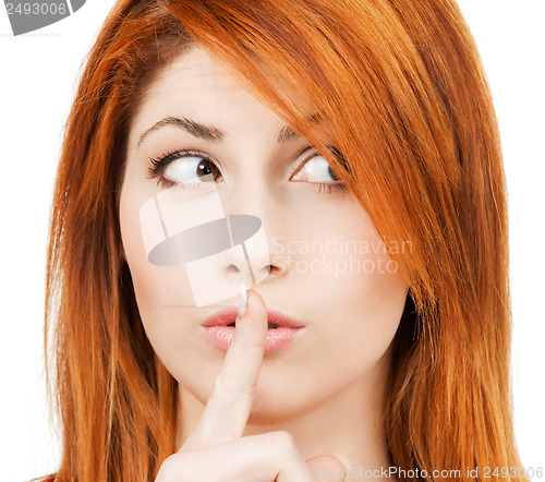 Image of woman with finger on her lips