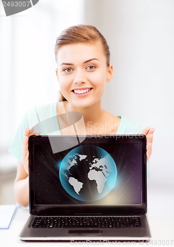 Image of woman with laptop and sphere globe