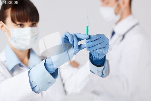 Image of doctors with syringe