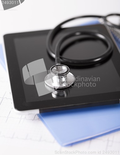 Image of tablet pc, stethoscope and electrocardiogram
