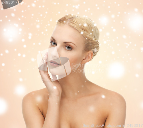 Image of face, hands and shoulders of beautiful woman