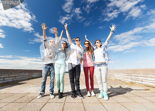Image of group of teenagers holding hands up