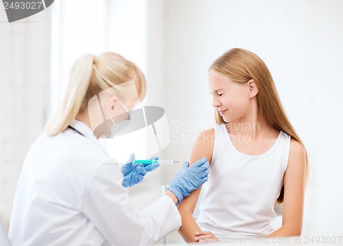 Image of doctor doing vaccine to child in hospital