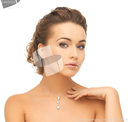 Image of woman wearing shiny diamond pendant