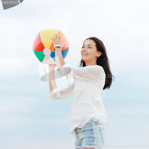 Image of girl with ball on the beach