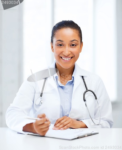 Image of female doctor writing prescription