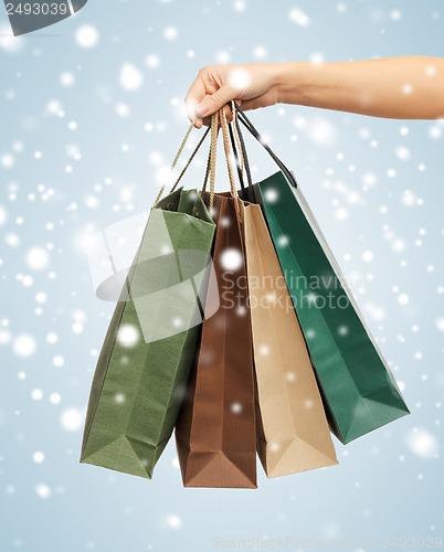 Image of woman hands holding shopping bags