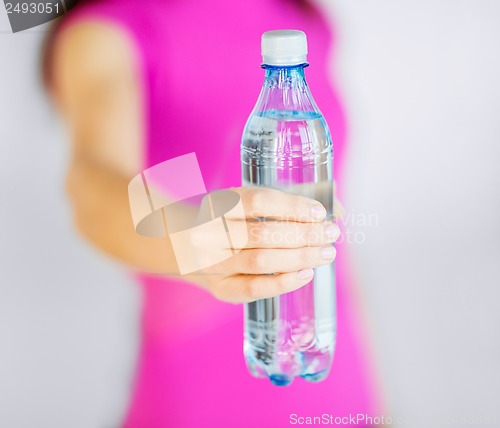 Image of sporty woman with bottle of water